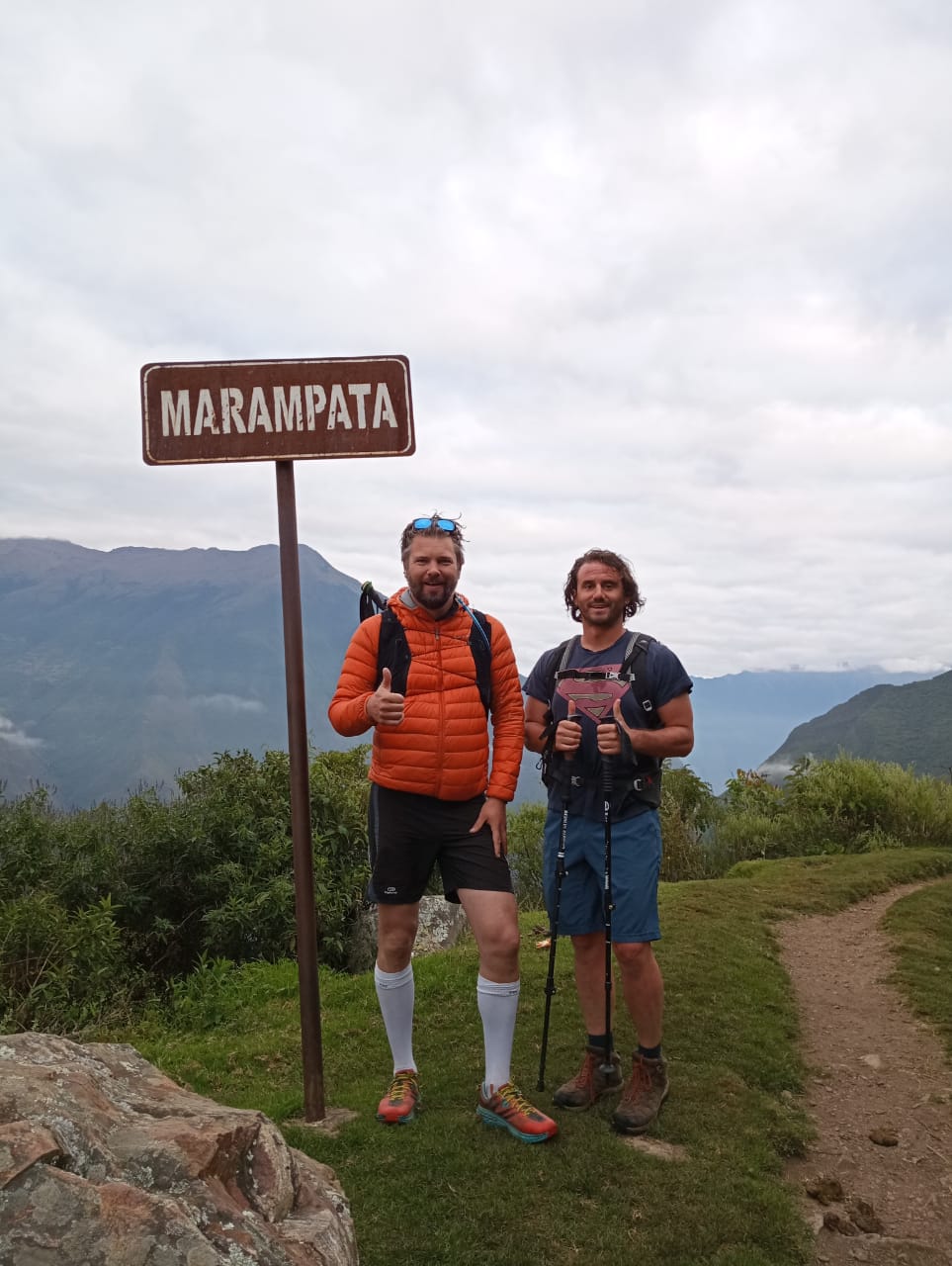 Two hikers at the Marampata sign on the Choquequirao 4 day hike.