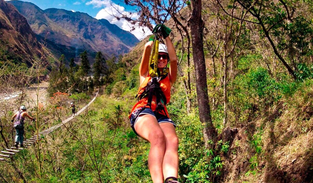 Woman ziplining over a mountain valley on the Inca Jungle Trek 3 days and 2 nights.