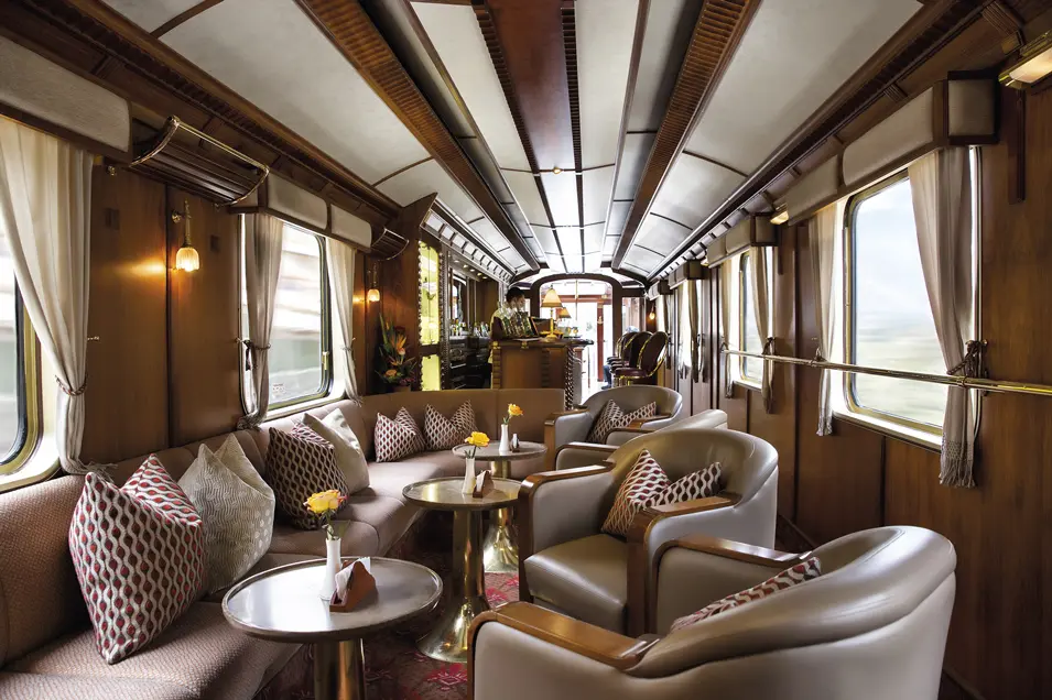Interior of a luxury car on the Hiram Bingham train, with comfortable seats, windows, and a bar, for a luxury tour to Machu Picchu.